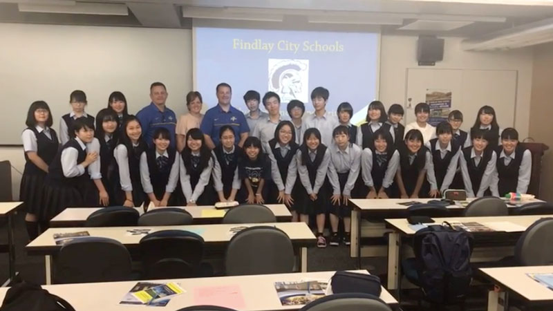 Group of students at Kawaguchi High School posing for a picture with visitors from Findlay City Schools