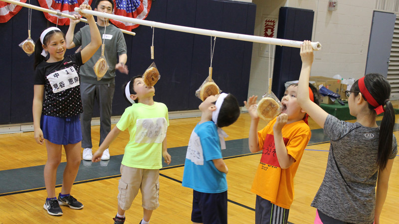 Students Ema Mitani Akiyuki Kado Haruki Asaoka Sora Toma and Hinata Ooi participate in fun games.