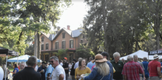 people gather in front of a house