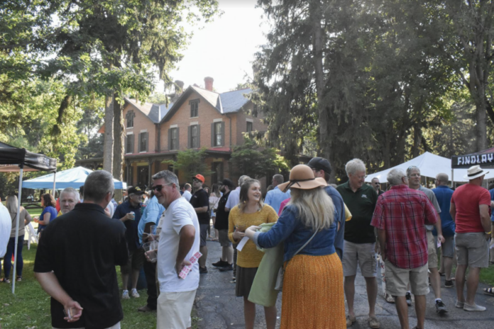 people gather in front of a house