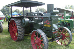 A green tractor with red wheels from a previous Antique Machinery Show.
